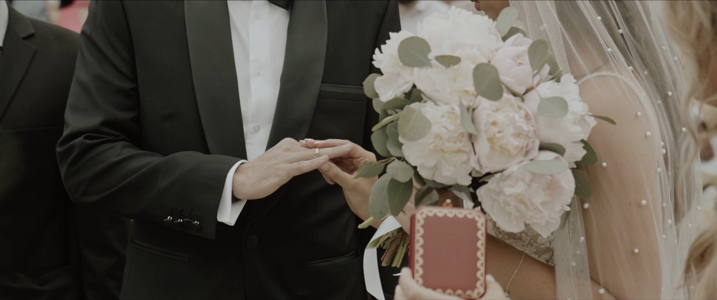 Ivana and Slobodan holding hands with the bridal bouquet